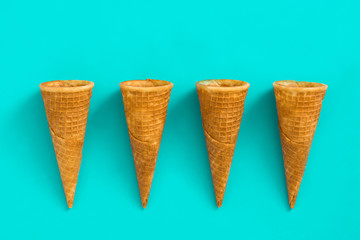 Empty ice cream cornets on blue background
