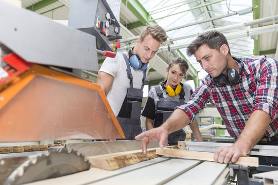 young apprentice with professional carpenter