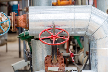 Faucet with steel pipes in natural gas processing plant in summer day