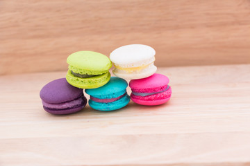 Sweet and colourful french macaroons or macaron on wood background, Dessert.
