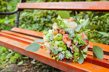 Wedding decor - a bowl of green apples, fresh flowers and lace ribbons