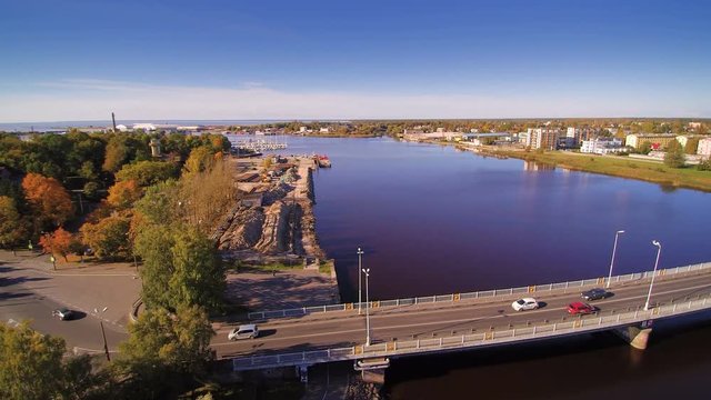 The city harbor in Parnu Estonia where trees and factories are on the harbor coast