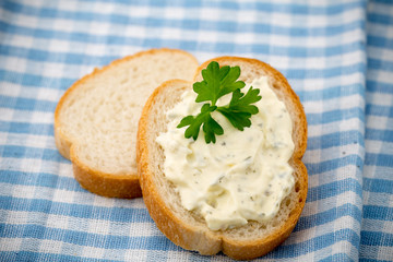 Bread with fresh cream cheese and red caviar on table.