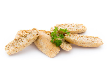 Dry flat bread crisps with herbs on a white background.
