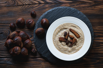 Above view of chestnut cream-soup topped with croutons