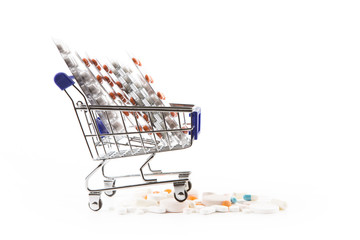 Isolated shopping cart full with pills and capsules