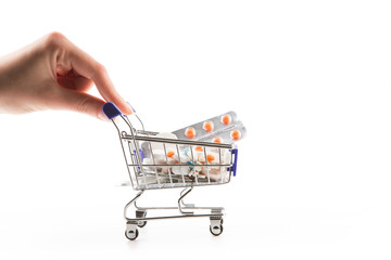 Fototapeta premium Isolated shopping cart full with pills and capsules