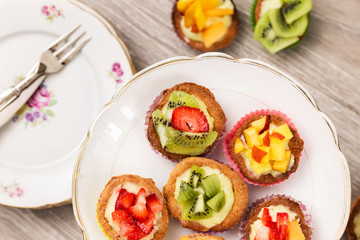 mini pastry with custard cream and fresh fruits over cake stand
