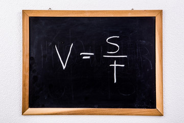 physics formula on blackboard