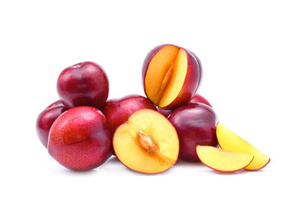 Red plums on white background