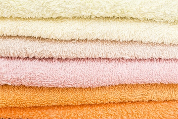 Fototapeta na wymiar freshly laundered bath towels stacked and folded in different colors 