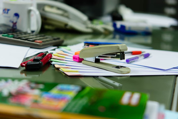 A desk full of papers placed the disorder, is putting things on