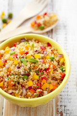 Quinoa salad with addition of pepper, red onion, green peas and fresh mint,  healthy and nutritious vegan dish