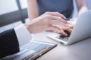 Business adviser analyzing financial figures denoting the progre