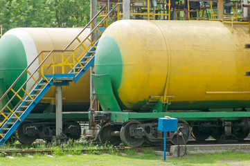 Old fuel tanks at the oil terminal on railway station on a summer day