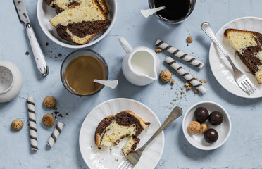Breakfast or snack table - coffee, cookies, candy, cake, cream on a blue stone  background