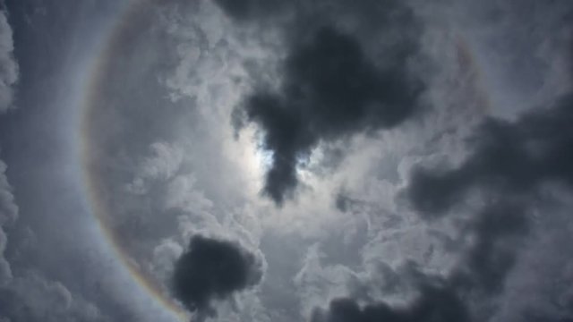 Sun with halo corona rainbow and nature cloudscape with blue sky and white cloud, Timelapse