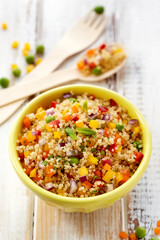 Quinoa salad with addition of pepper, red onion, green peas and fresh mint,  healthy and nutritious vegan dish