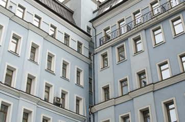 blue facade of a building with lots of windows