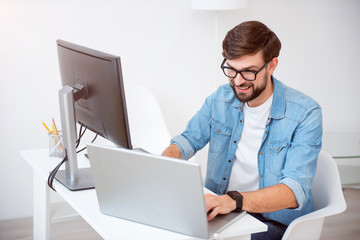 Happy young man working on his laptop