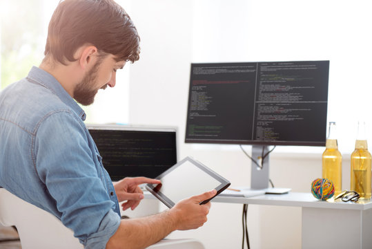 Happy young man using his tablet