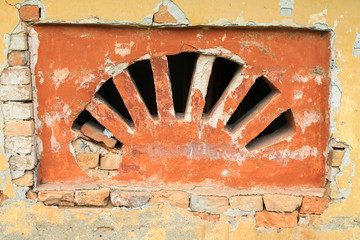 Close up of brick wall with grill and reinforced concrete coveri