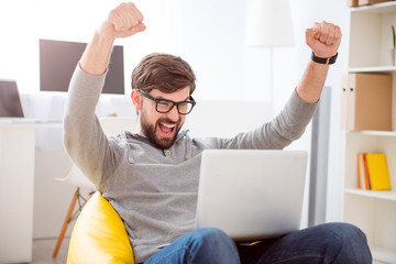 Man raising hands in sign of victory
