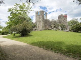 Fototapeta na wymiar Guimaraes castle with the flag of the city, north of Portugal