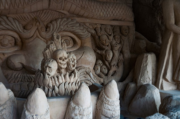 Horror sculpture with big and small face in a low dark light