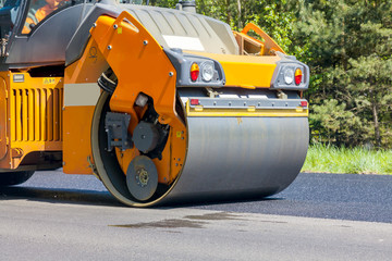 Road roller flattening new asphalt