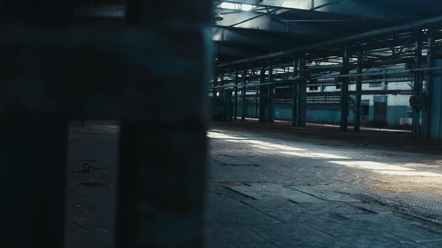 Left to right dolly wide angle shot of abandoned factory interior. Scary, catastrophe, horror concept. Blackmagic URSA Mini RAW graded footage