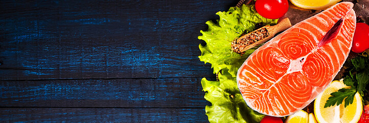 Composition with fresh salmon, herbs, parmesan and spices. Food background. Space for text