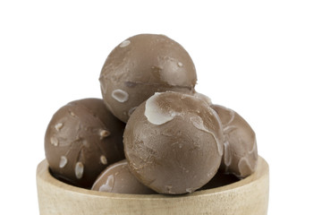 chocolate balls in wooden cup.