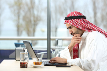 Arab saudi man worried with laptop