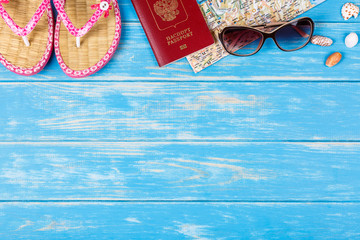 View of travel items lying on blue wooden background.