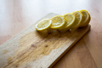 Lemon slices on a kitchen wooden board