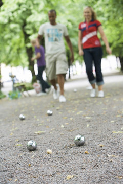 Three people playing boules, Stockholm, Sweden.