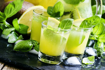 Spicy fruit lemonade with basil, kiwi, lemon, soda and ice, blac