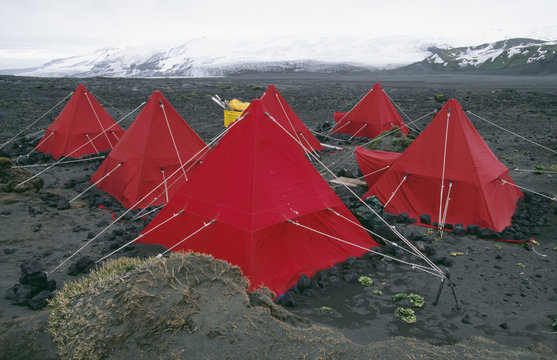 Tents with snow-covered mountains in background