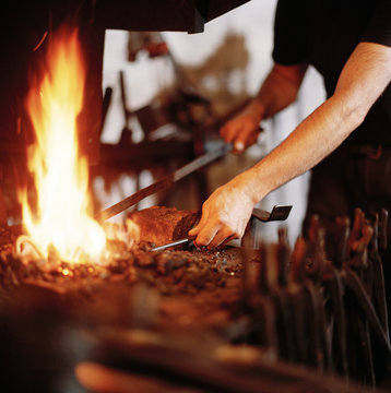 A smith hammering.