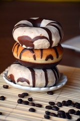 Donuts with chocolate on a brown plate on the table