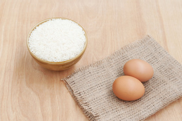 White rice in brown bowl with egg on wooden