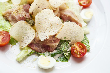 Caesar salad with croutons, tomatoes, bacon and chicken