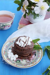 Chocolate pancakes with marshmallows at breakfast