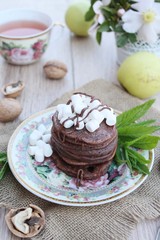 Chocolate pancakes with marshmallows at breakfast