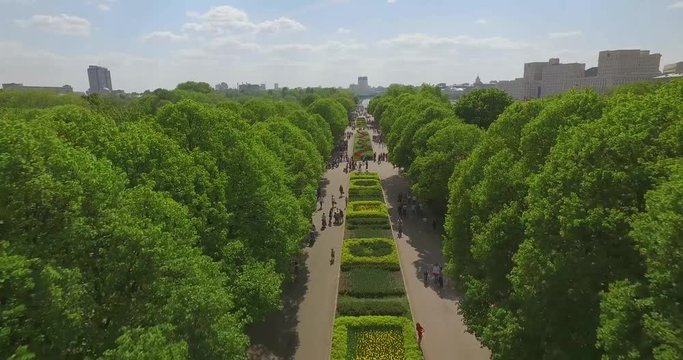 Aerial View Of Green Trees In The Park, Cityscape, Flowerbeds, Crowds Of People Walking On The Sidewalks, River Bank, Moscow River On Sunny Summer Day. Gorky Park, Moscow, Russia.