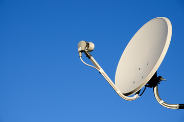 Satellite TV antenna on sky background