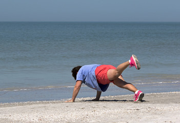 Senior woman exercising on a Gulf Coast beach.
