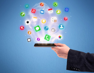 Hand holding tablet phone with app icons