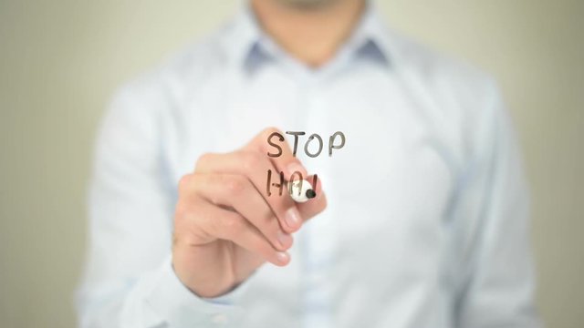 Stop Hate Speech , man writing on transparent screen
